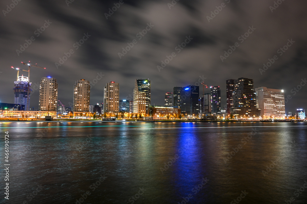 City of Rotterdam by night. Panoramic view of skyscrapers and lights on buildings in town. Night skyline in Rotterdam, Netherlands, Holland.
