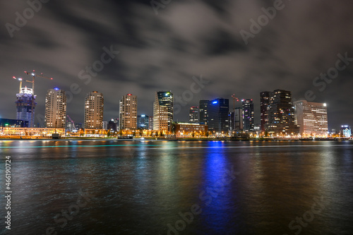 City of Rotterdam by night. Panoramic view of skyscrapers and lights on buildings in town. Night skyline in Rotterdam, Netherlands, Holland.
