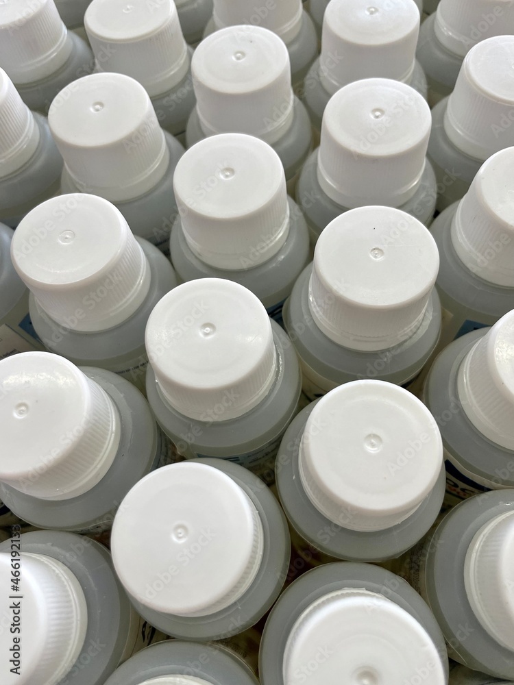picture full of white plastic caps with their cans, sorted. close up. and different views picture full of white plastic caps with their cans, sorted. close up. and different views