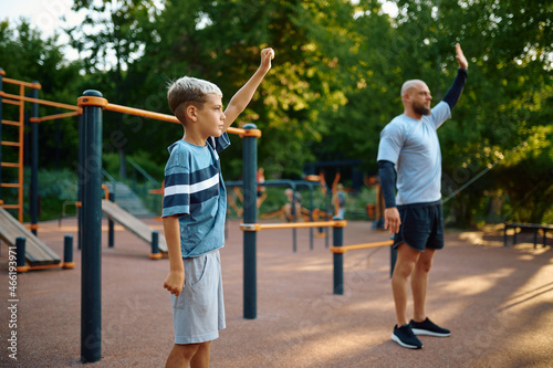 Dad and son, sport training on playground © Nomad_Soul