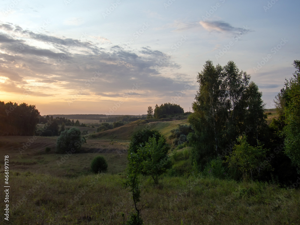 sunset on a clear day over a wooded ravine sunset on a clear day over a wooded ravine