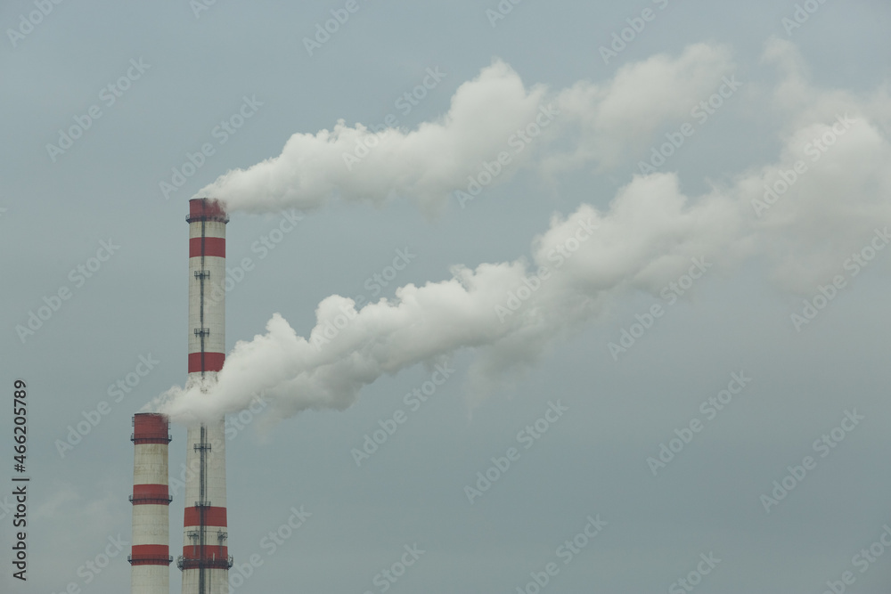 Smoke emanates from the chimney of an industrial enterprise, which pollutes the air. Smoke emanates from the chimney of an industrial enterprise, which pollutes the air.