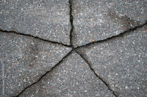 Cracked asphalt texture. View from above. Close-up