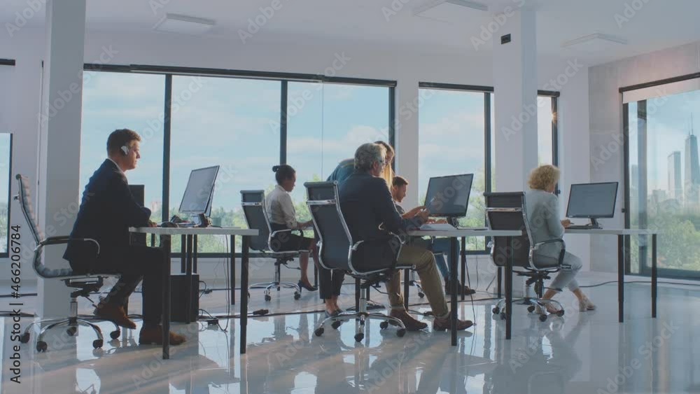 Timelapse footage of colleagues cooperating at work. Modern workplace with natural light. Modern open space office interior.