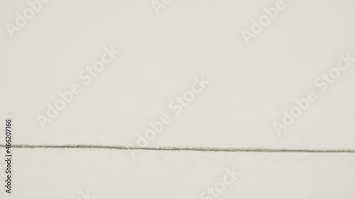 Graphite pencil draws a straight line on a white background paper, macro shot photo