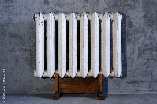 Old shabby cast iron household hot-water heating radiator