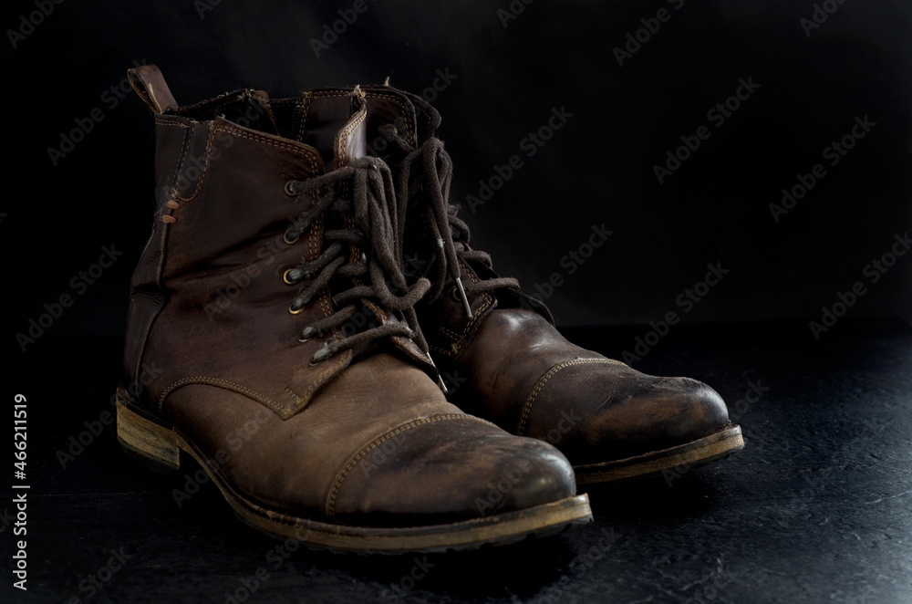 Side View of Old Dusty Brown Leather Boots