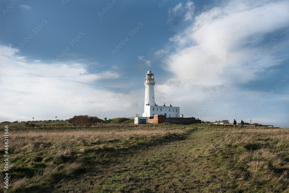 Flamborough, Yorkshire, United Kingdom - 20 December 2020: Bridlighton bay, New Flamborough lighthouse on blue sky. 