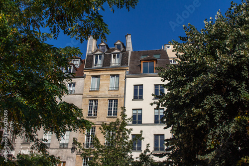 Close  upward exterior view of traditional building architecture in France  with stone walls and beautiful ornate French balconettes