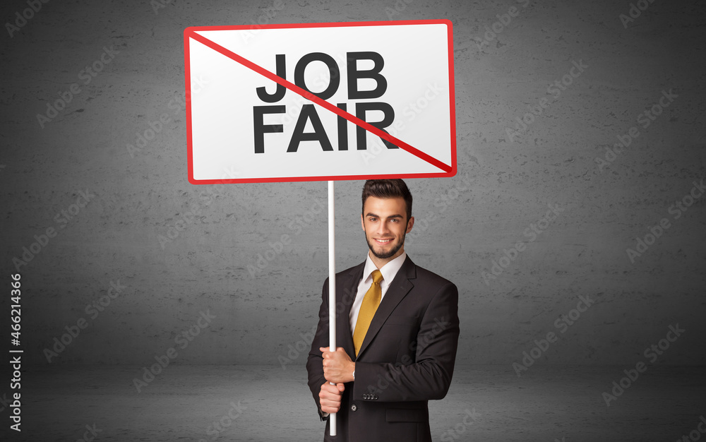 business person holding a traffic sign business person holding a traffic sign