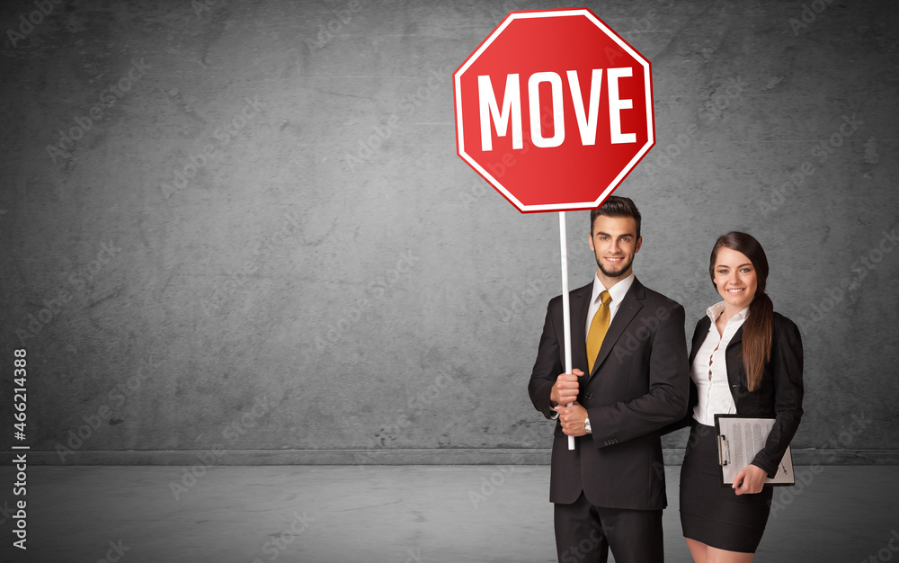 Young business person holding road sign Young business person holding road sign