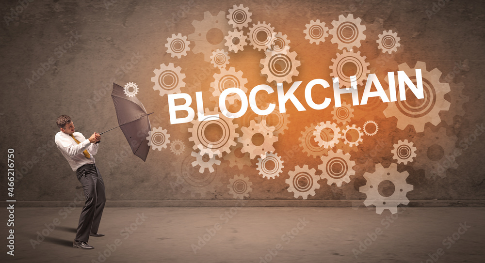 Fototapeta premium Businessman defending with umbrella concept