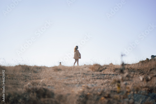 Women walking at a field with a dog