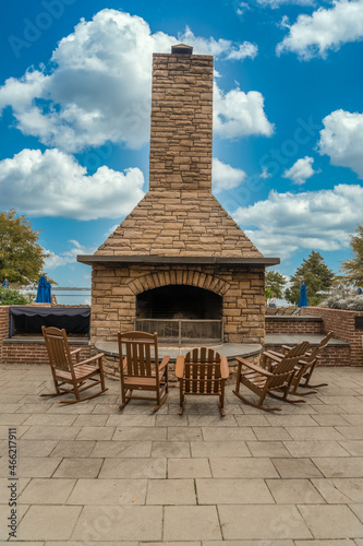 Quadro su tela Outdoor patio fireplace with chimney covered in stone veneer to roast marshmallo