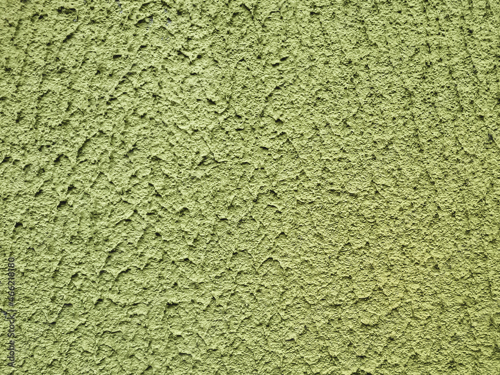 Green beautiful uneven plastered background from a rough wall. Great idea for design, close-up Green beautiful uneven plastered background from a rough wall. Great idea for design, close-up
