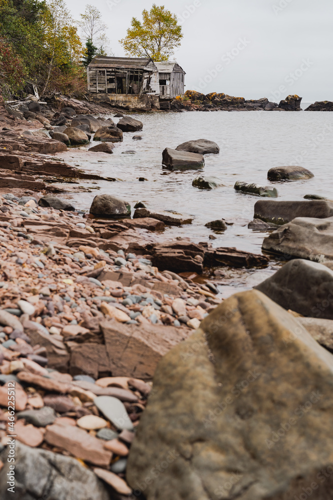 Fototapeta premium Abandoned fishing shacks or cabins, on Two Fishhouse Beach along Lake Superior shoreline in Minnesota, during fall
