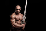 Ferocious muscular ancient warrior barbarian with fantasy sword on black background