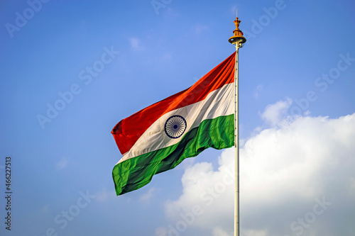 Indian National Flag , flying high in the sky on a beautiful , clear blue sky background.