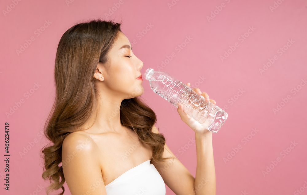 Beautiful Young Asian Woman short hair with Clean Fresh Skin. Face care, Facial treatment, Cosmetology, beauty and healthy skin and cosmetic ideas concept.pretty woman drinking water.. Beautiful Young Asian Woman short hair with Clean Fresh Skin. Face care, Facial treatment, Cosmetology, beauty and healthy skin and cosmetic ideas concept.pretty woman drinking water..