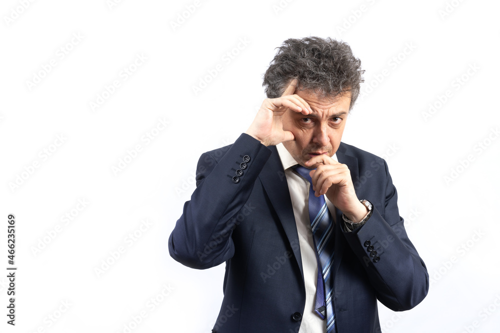 An unshaven middle-aged man in a business suit with disheveled hair and an emotional face looks straight ahead An unshaven middle-aged man in a business suit with disheveled hair and an emotional face looks straight ahead