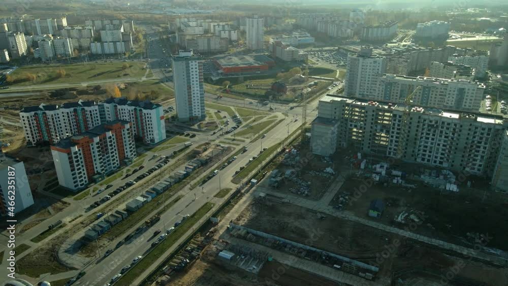 Flight over city blocks. Multi-storey buildings and construction site. Flying in the backlight of the setting sun. Aerial photography. Flight over city blocks. Multi-storey buildings and construction site. Flying in the backlight of the setting sun. Aerial photography.