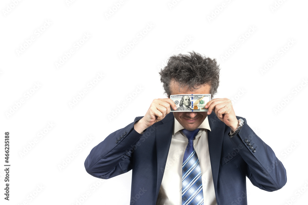 An unshaven middle-aged man in a business suit with disheveled hair and an emotional face holds 100 US dollar bills An unshaven middle-aged man in a business suit with disheveled hair and an emotional face holds 100 US dollar bills