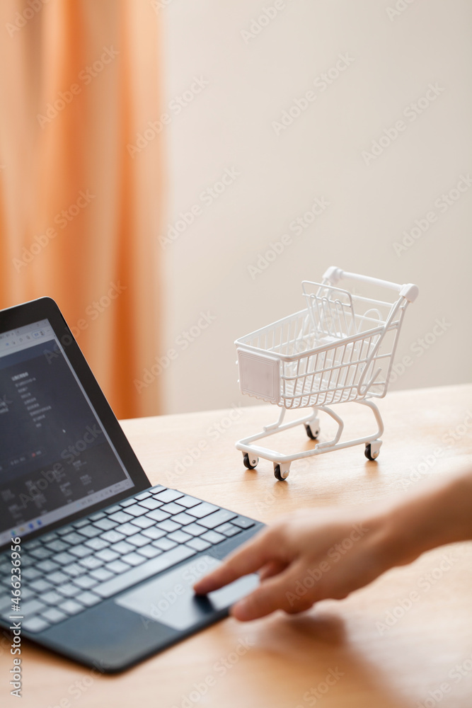 a hand typing on keyboard of laptop, online shopping concept.