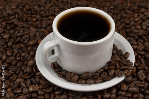 White cup with coffee on coffee grains. Honduran hot coffee