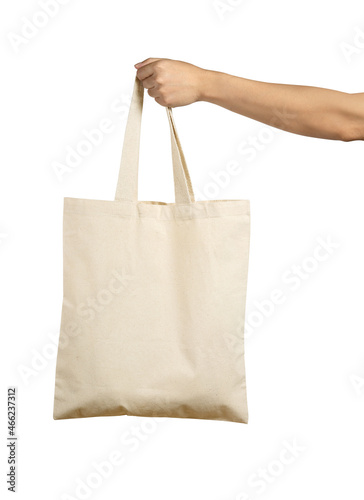 Hand Holding Beige Colour Canvas Tote Bag Isolated on White Background.