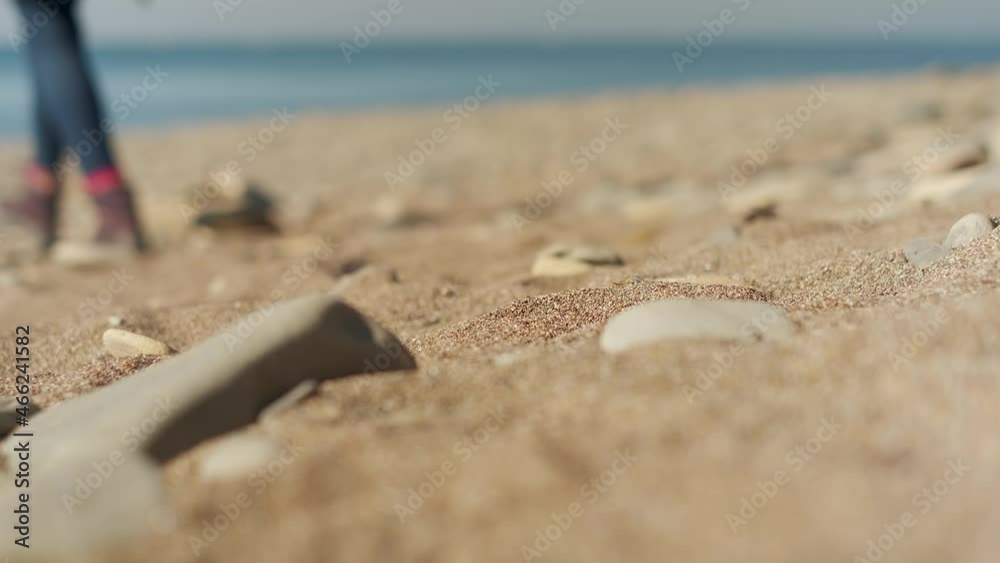 4 K. Close-up, selective focus on the sandy sea beach, a tourist in hiked boots walks to the beach. The idea of travel and relaxation 4 K. Close-up, selective focus on the sandy sea beach, a tourist in hiked boots walks to the beach. The idea of travel and relaxation