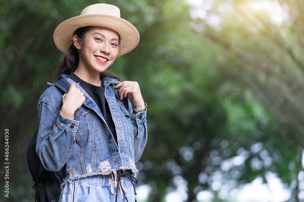 Young Asian woman explores the forest on holiday