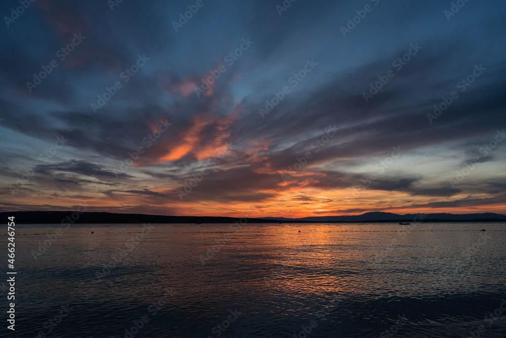 Panorama with a fisherman's boat in the afterglow over the Croatian coast. A summer scene.