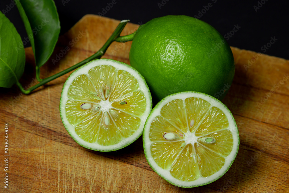 Sliced lime on a wooden board. Sour fruit. Citrus fruit