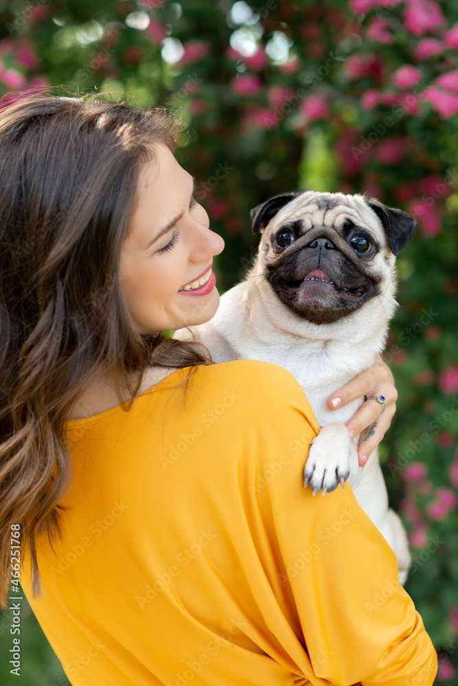 Spring girl, portrait,girl in a blooming garden,smile,girl with dog,pug, girl with pug