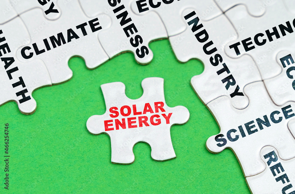 On a green background, white puzzles with text, a puzzle with the inscription - Solar Energy On a green background, white puzzles with text, a puzzle with the inscription - Solar Energy