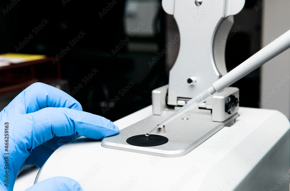 Scientist loads sample onto the low pedestal of Nanodrop for measuring