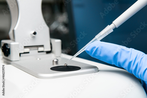 Close-up of loading sample onto low pedestal of Nanodrop by micropipette photo