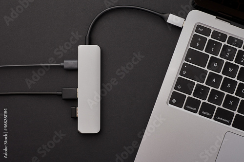 Close-up photo of type-c hub with cables and SD card connected to laptop