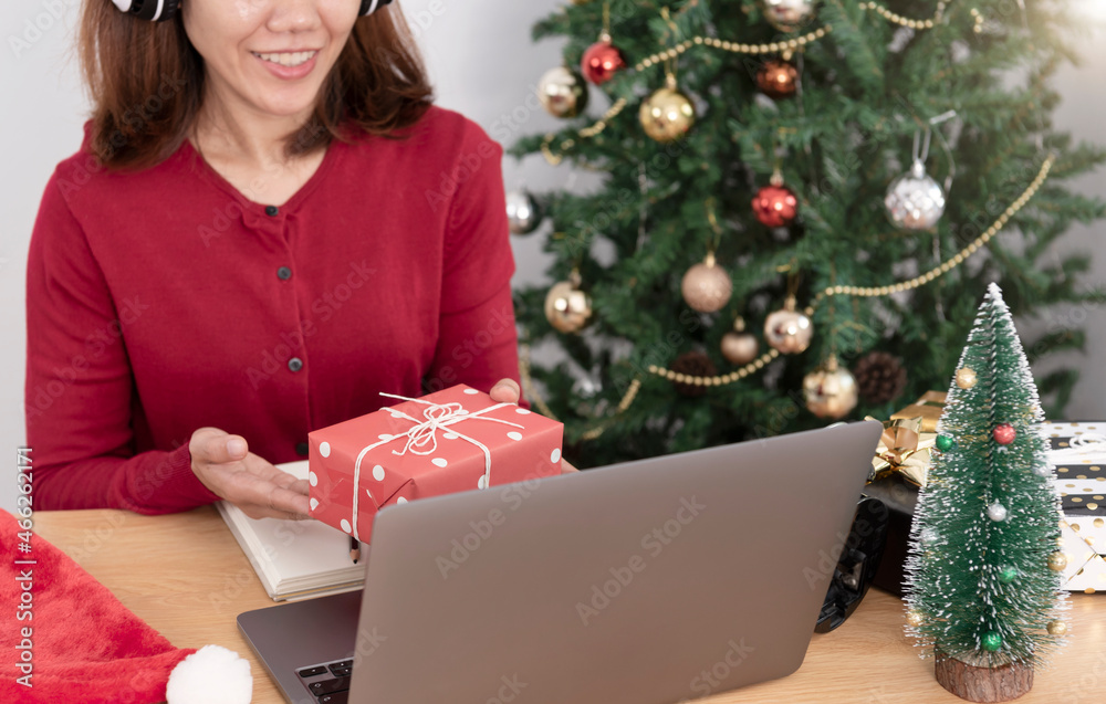 business woman holding giftbox on office table in Christmas day. business woman holding giftbox on office table in Christmas day.
