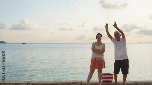 Asian elder senior couple retirement fun beach ocean trip healthy relationship and financial status