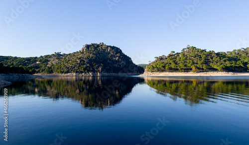 Mountain landscape reflected in the water of a lake. Copy space.