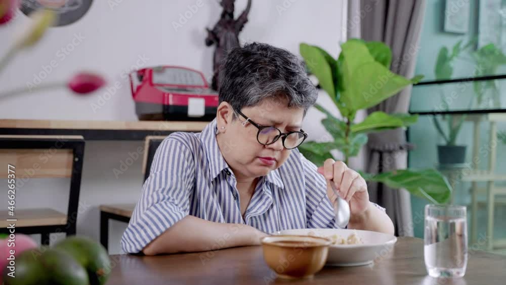 Elderly Asian woman eating alone, lonely, mental health problem
Elderly Asian woman eating alone, lonely, mental health problem