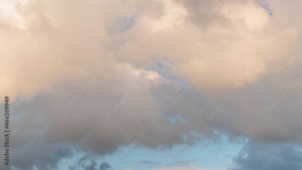 Timelapse - fast moving dramatic clouds against blue sky at sunset. Nature, freedom, time lapse concept