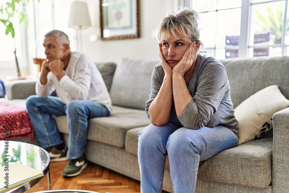 Senior caucasian couple in trouble sitting on the sofa at home. Senior caucasian couple in trouble sitting on the sofa at home.