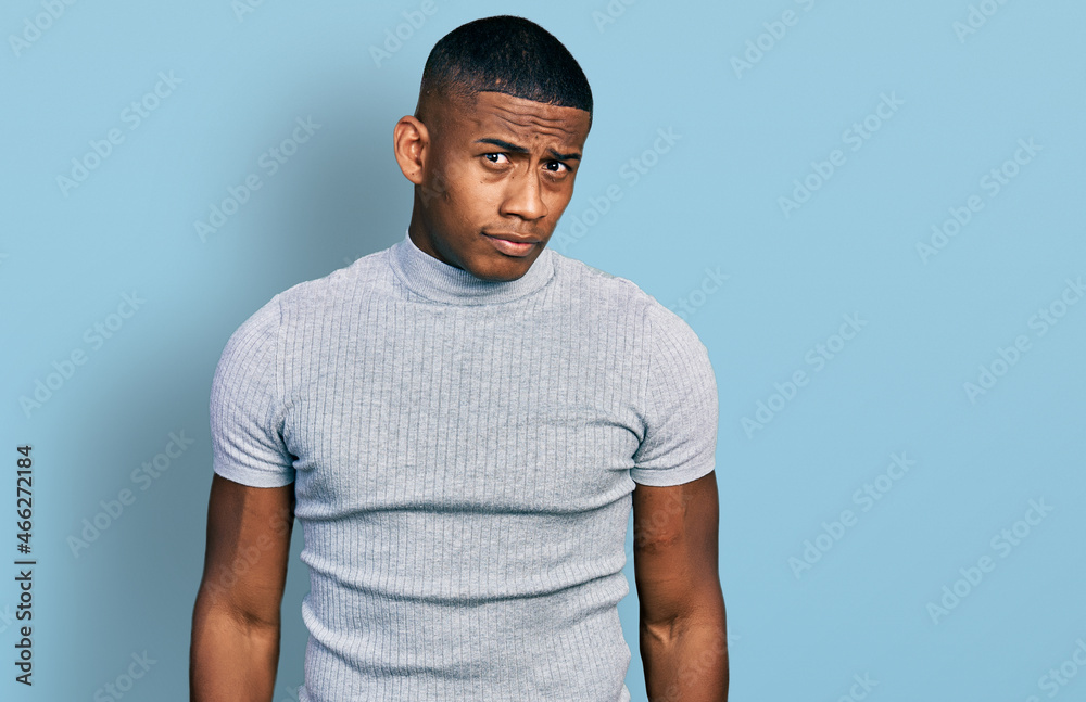 Young black man wearing casual t shirt skeptic and nervous, frowning upset because of problem. negative person. Young black man wearing casual t shirt skeptic and nervous, frowning upset because of problem. negative person.