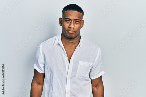 Young black man wearing casual white shirt depressed and worry for distress, crying angry and afraid. sad expression.