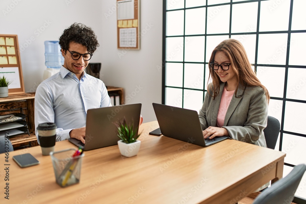 Two business workers smiling happy working at the office. Two business workers smiling happy working at the office.