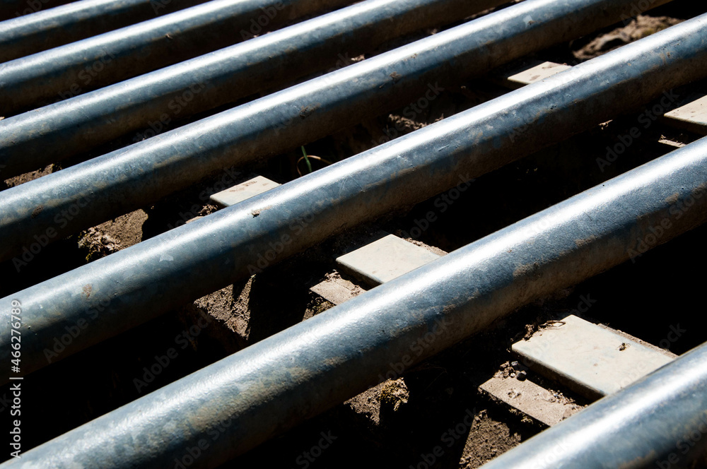 Close-up of a metal cattle grid or cattle guard with concrete supports Close-up of a metal cattle grid or cattle guard with concrete supports