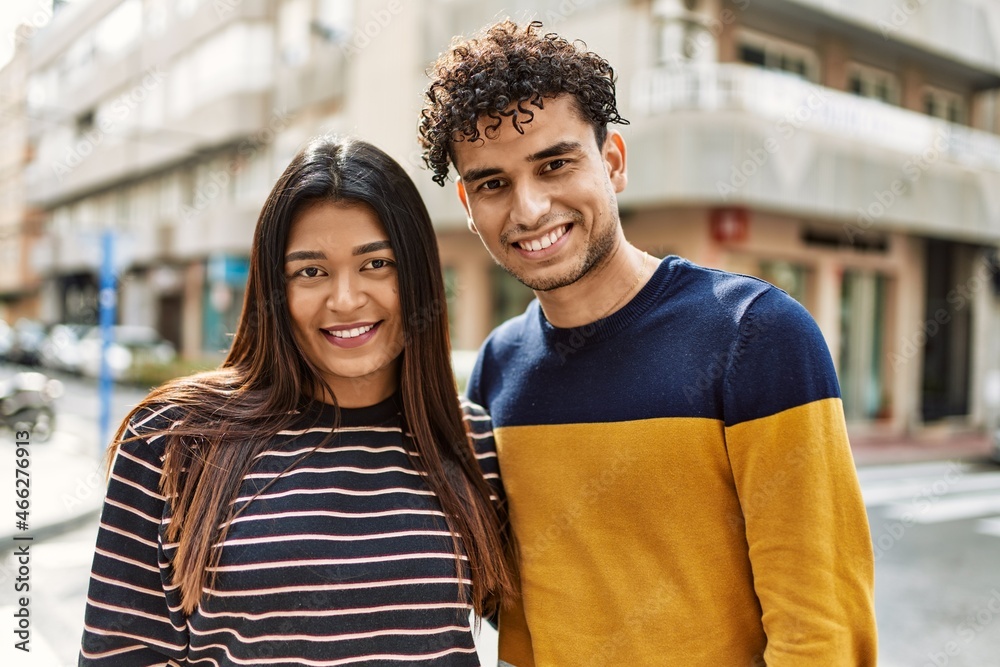 Young latin couple smiling happy and hugging at the city. Young latin couple smiling happy and hugging at the city.