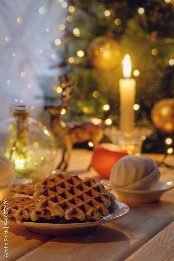 Christmas table with sweets. Celebrating Christmas Eve. Christmas sweet cookies, marshmallows on the table under the Christmas tree